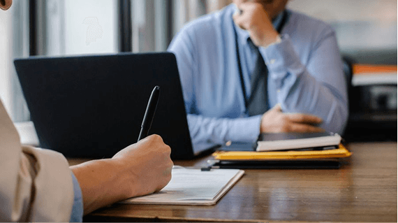 Security analyst reviewing audit activity on a laptop